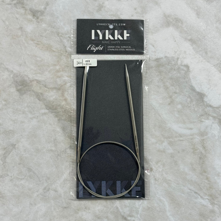 A package of LYKKE circular knitting needles, size 24, in a clear plastic sleeve with a black header card, placed on a light gray marble surface.