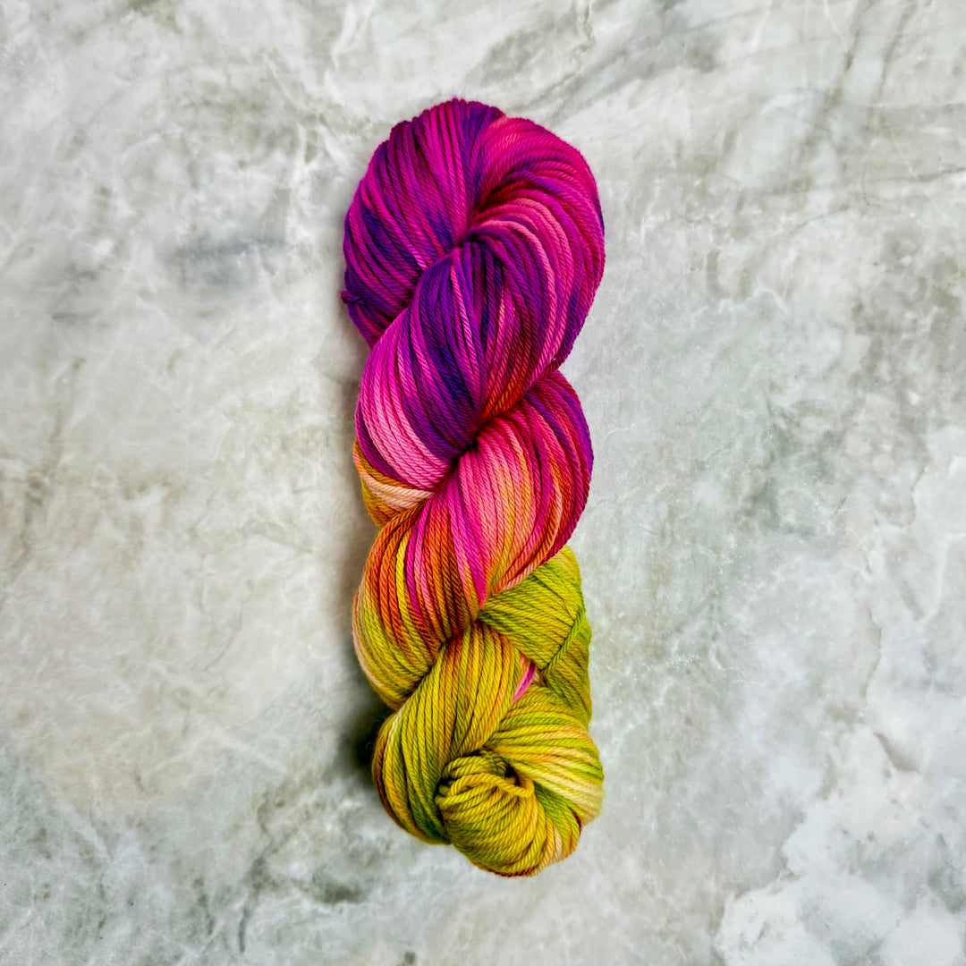 Multicolored skein of yarn on a textured gray background