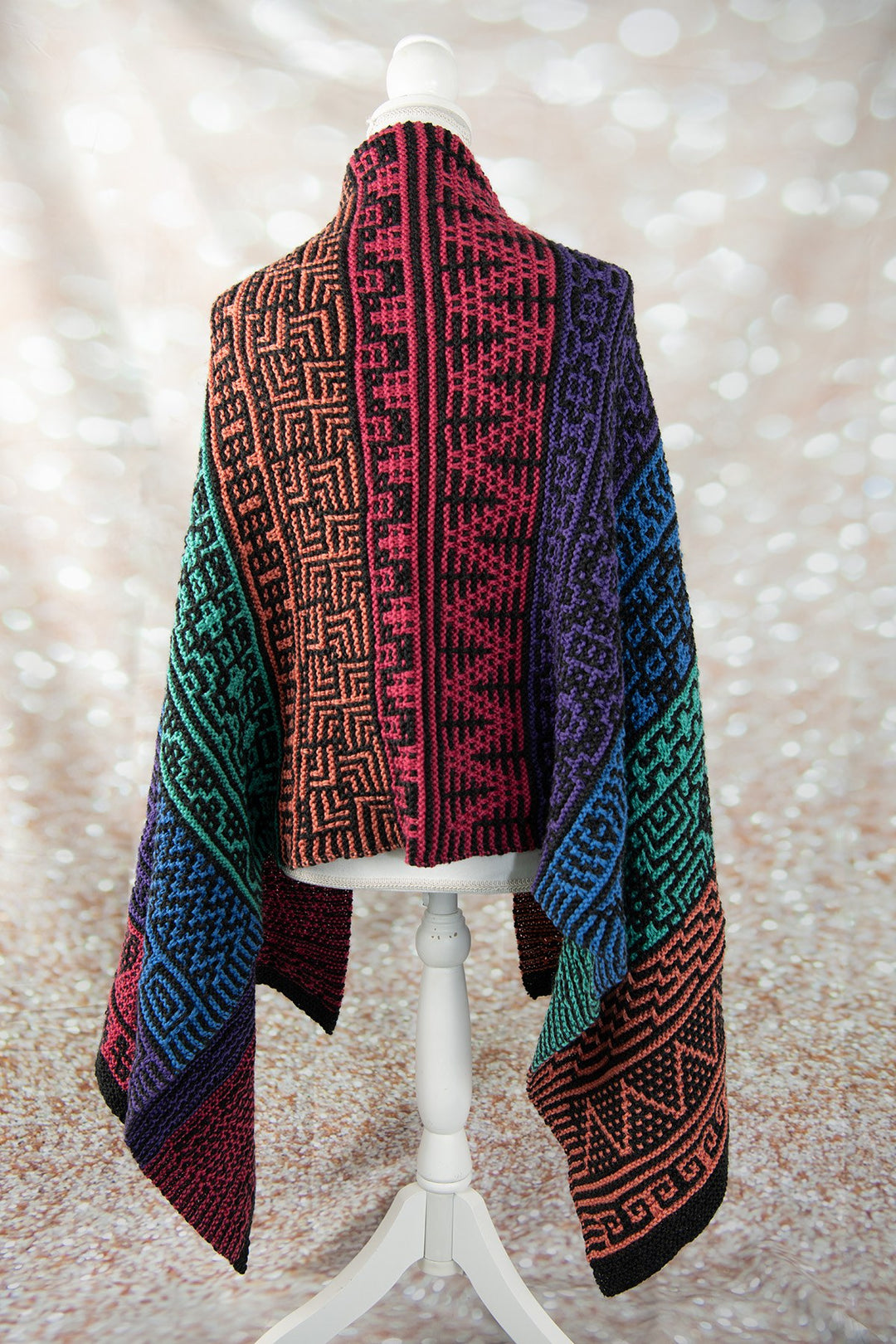 Colorful mosaic knit wrap in Cascade yarn, shown on a dress form
