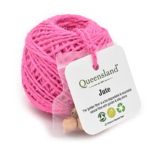 Pink jute ball with a Queensland brand label on a white background