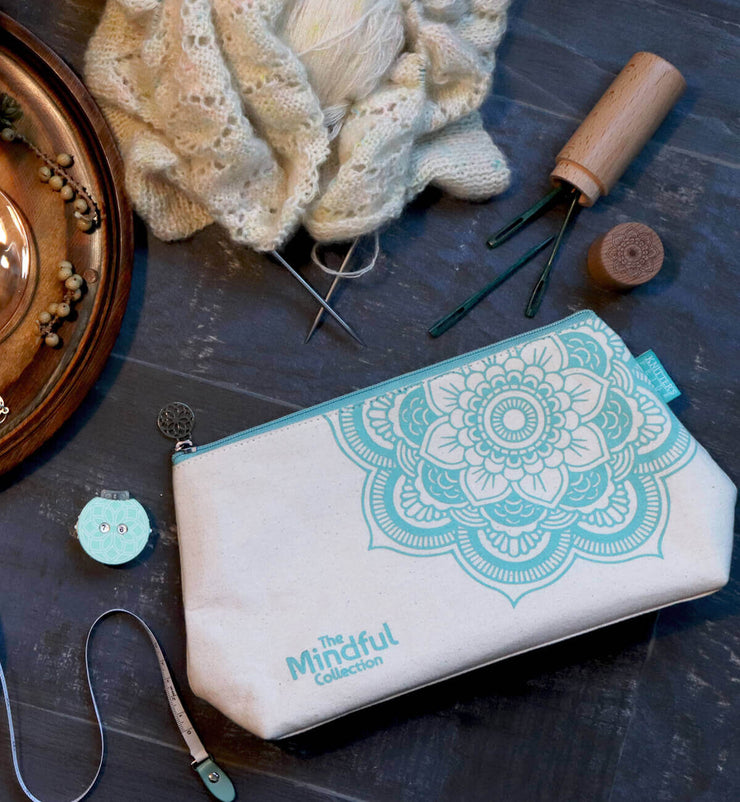 Perfectly sized storage solution for carry small projects and needles.  Coordinates with The Mindful Collection theme with floral pattern & colors.  Zippered pocket inside to carry small notions.  Mandala shaped charm for zipper pull.  DIMENSION :- 10"(H) X 6.5"(W) X 3"(D)