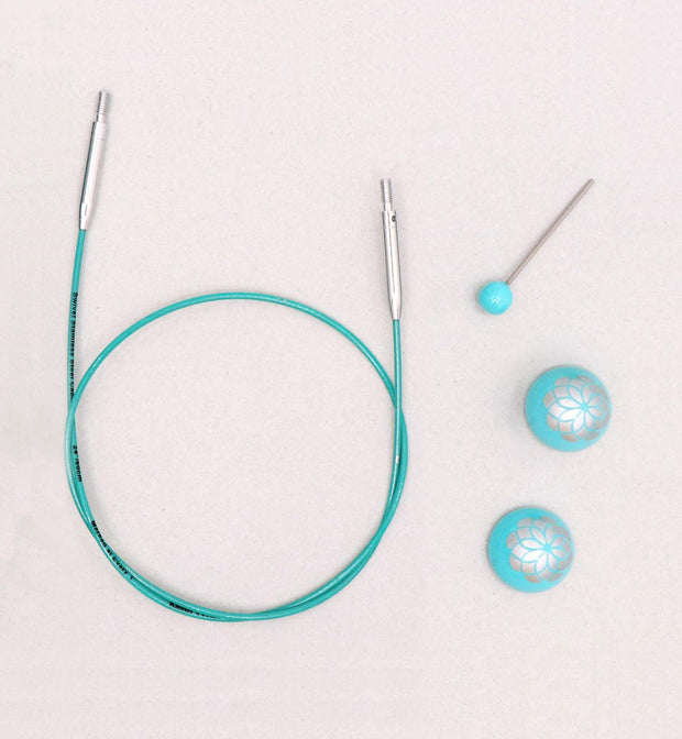 Strong and flexible - made of finest grade material.  Smooth coated and teal in color.  Allows your interchangeable tips to swivel freely.  Memory free cord for no twisting.  Marked at 1" intervals for convenient measuring.  Offered with teal colored end caps with the floral print are a delight to use and the cord keys used for tightening the tips to the cord come with a color coordinated top.  The Mindful Collection Smart Cords will work with all Knitter's Pride needles.  Comes with 1 cord key & 2 end caps